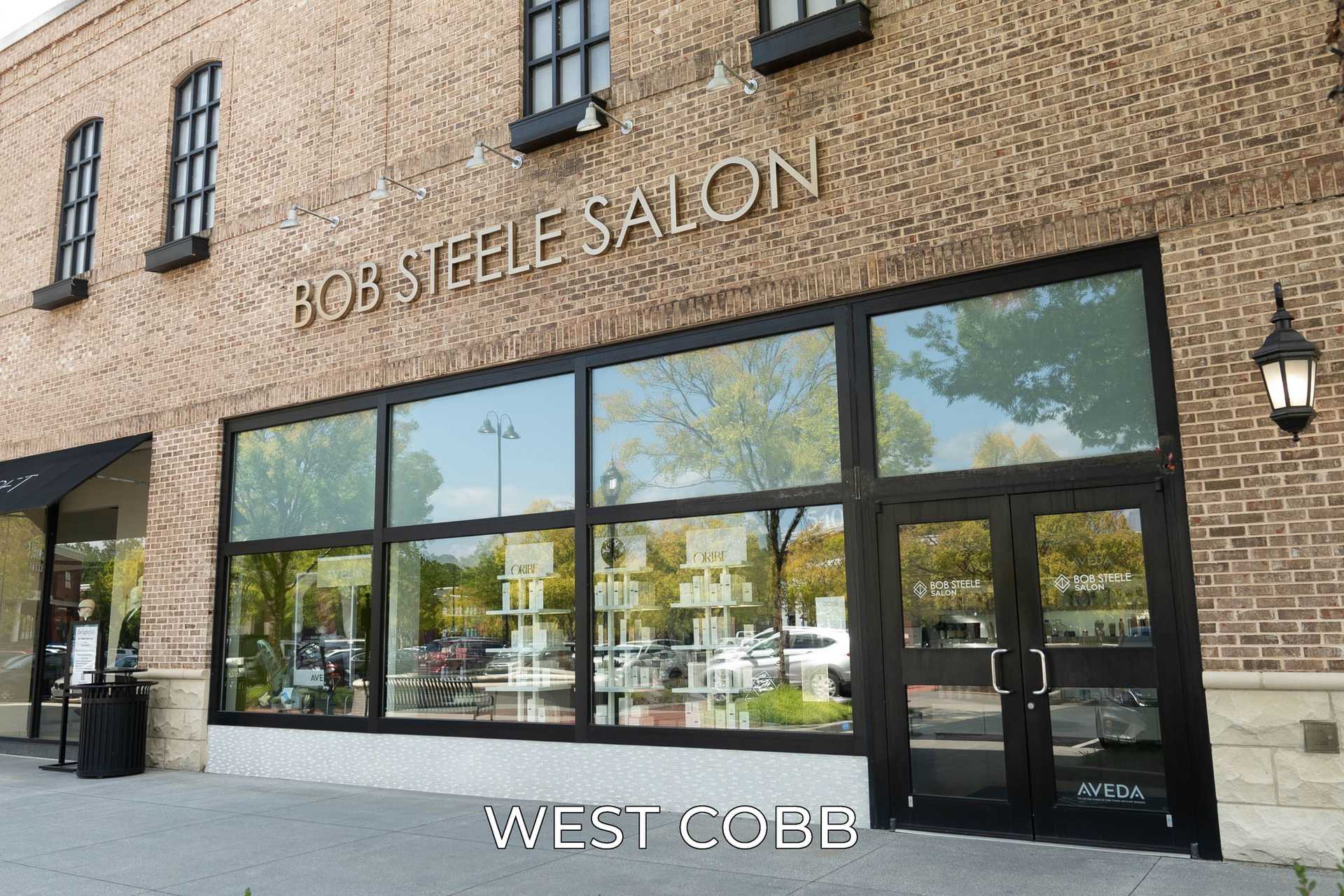 Bob Steele Salon storefront with large glass windows and brick facade at West Cobb location.