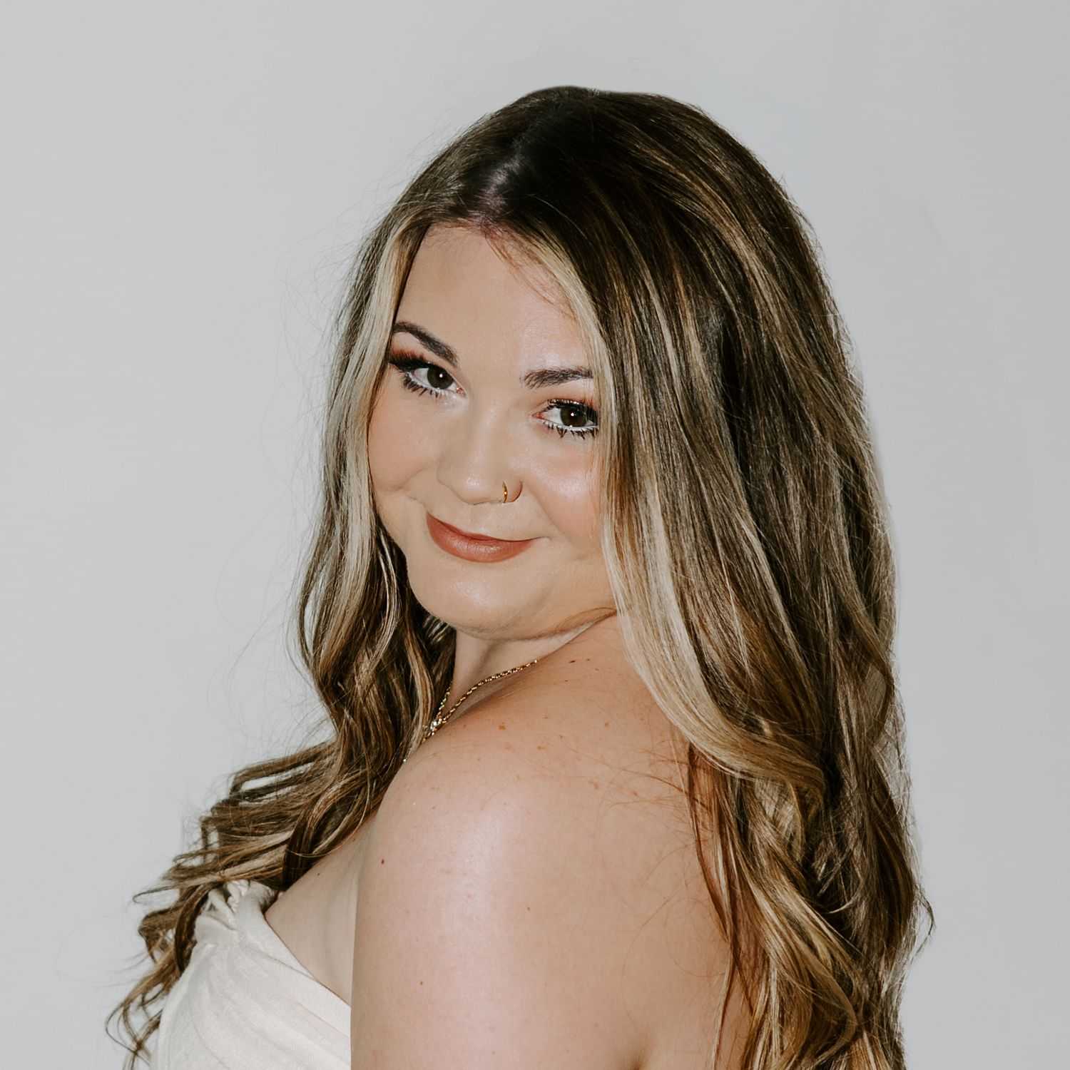Portrait of Kait  ​, a professional stylist at Bob Steele Salon, showcasing their expertise and style.