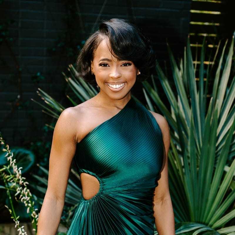 Portrait of Ashanti, a professional stylist at Bob Steele Salon, showcasing their expertise and style.