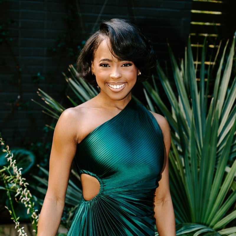 Portrait of Ashanti, a professional stylist at Bob Steele Salon, showcasing their expertise and style.