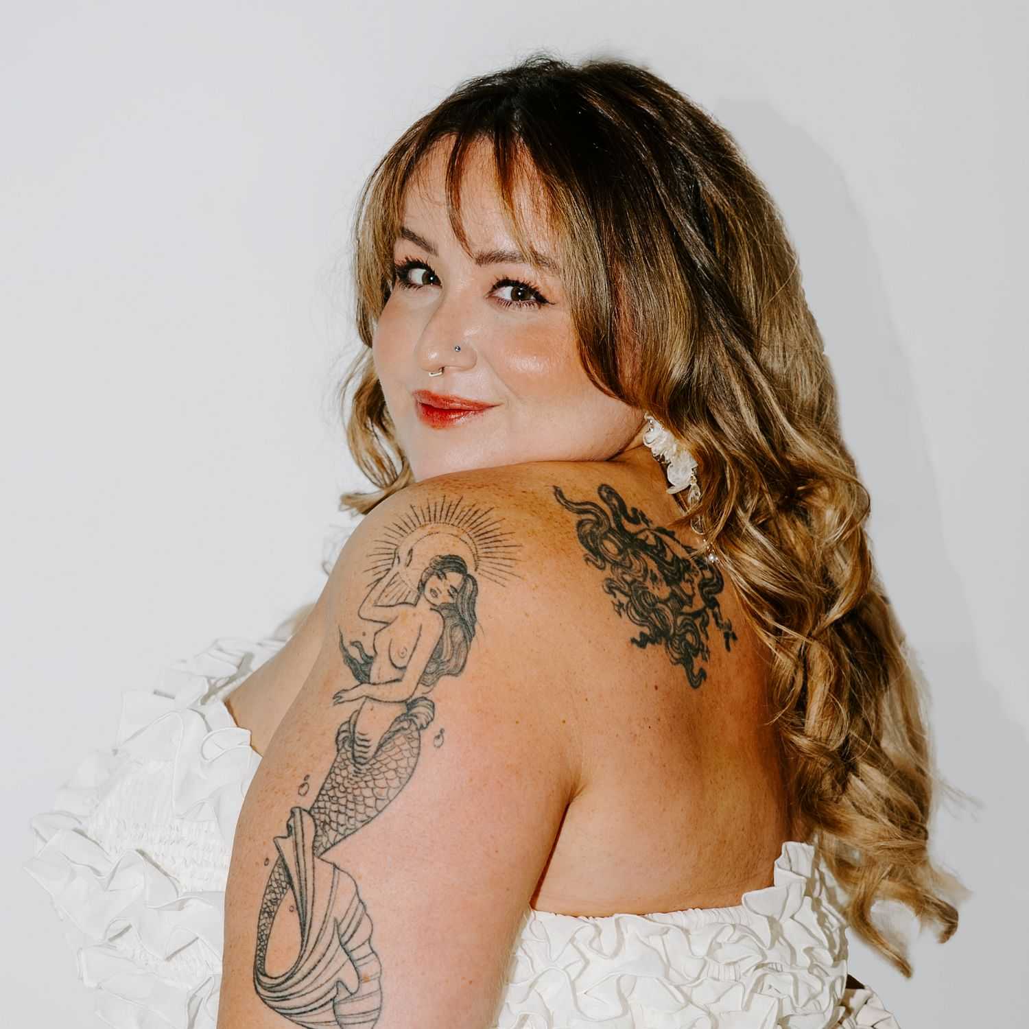 Portrait of Bella, a professional stylist at Bob Steele Salon, showcasing their expertise and style.